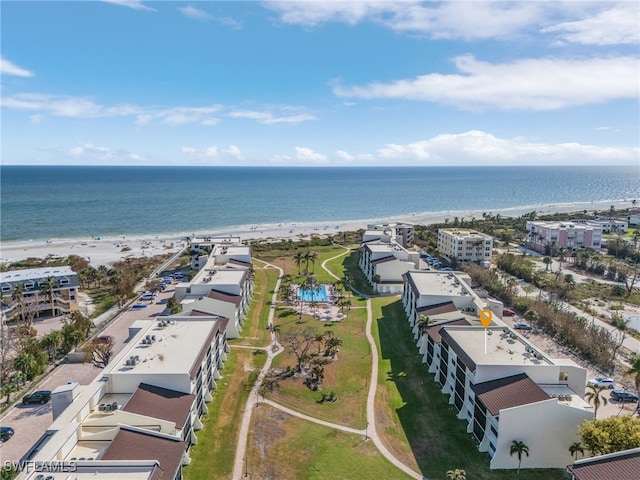 birds eye view of property featuring a beach view and a water view