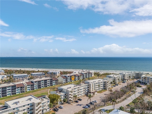 drone / aerial view featuring a water view and a beach view