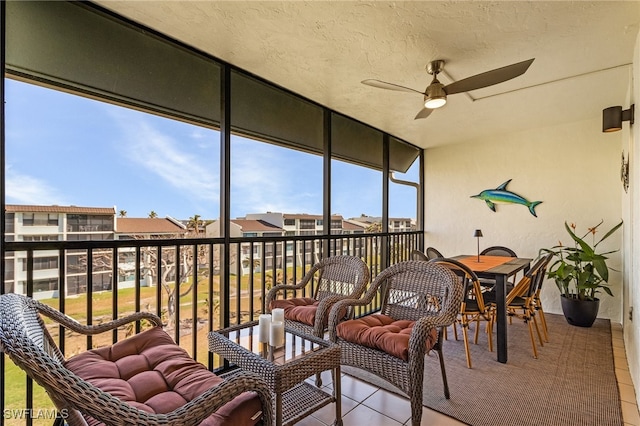 sunroom / solarium featuring ceiling fan