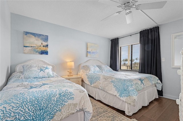 bedroom with a textured ceiling, ceiling fan, and dark wood-type flooring