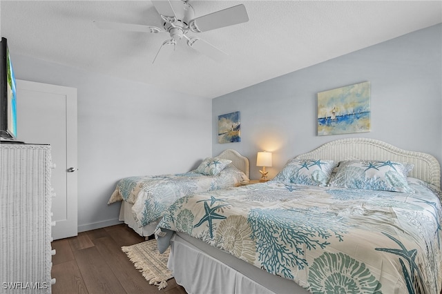 bedroom with dark hardwood / wood-style floors and ceiling fan