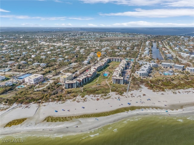 birds eye view of property with a view of the beach and a water view