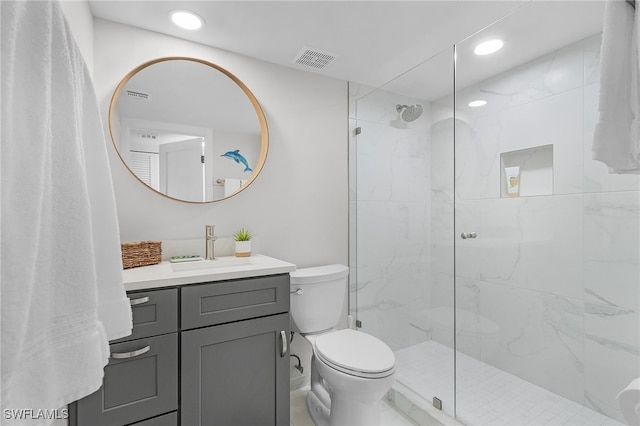 bathroom with vanity, an enclosed shower, and toilet