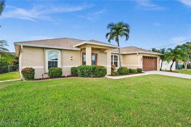 view of front of property featuring a garage and a front yard