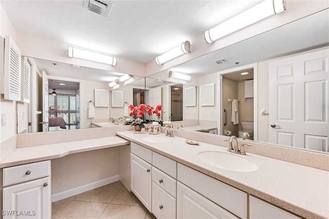 bathroom featuring toilet, tile patterned floors, and vanity