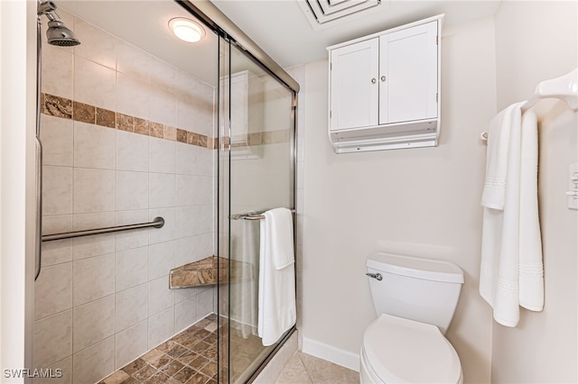 bathroom featuring toilet and a shower with shower door