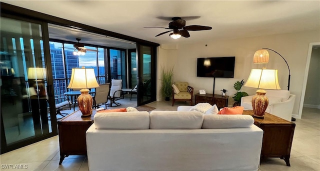 living room with floor to ceiling windows, ceiling fan, and tile patterned flooring