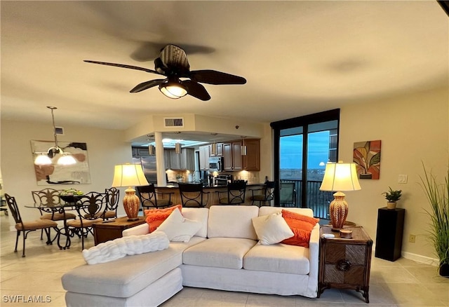 living room with ceiling fan with notable chandelier