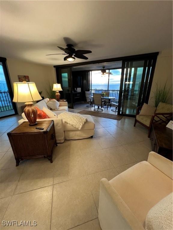 living room featuring ceiling fan, light tile patterned floors, and floor to ceiling windows