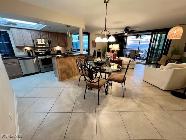 dining room with ceiling fan and light tile patterned flooring