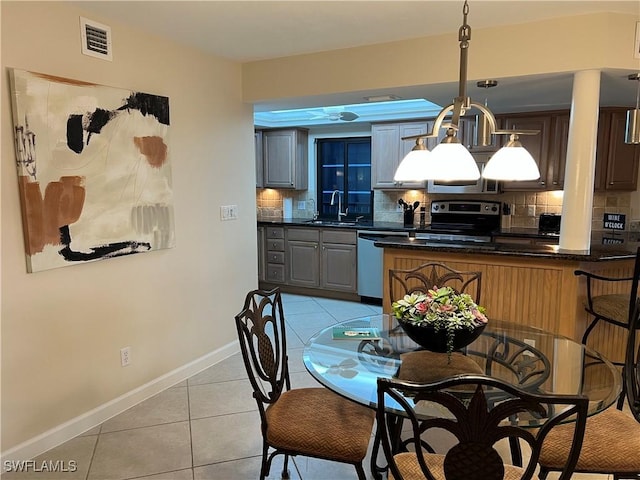 dining room with sink and light tile patterned flooring