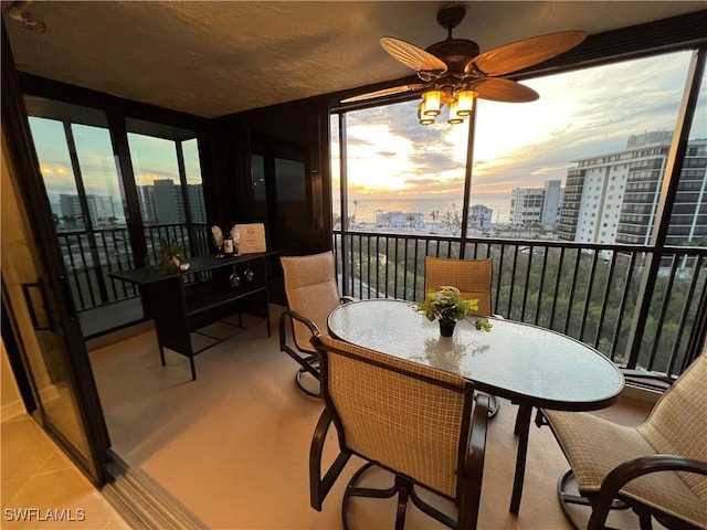 sunroom featuring ceiling fan