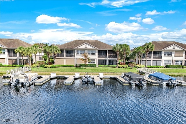 exterior space featuring a yard, a water view, and a balcony