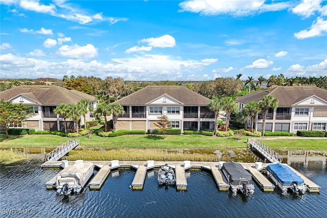 back of house with a sunroom and a water view