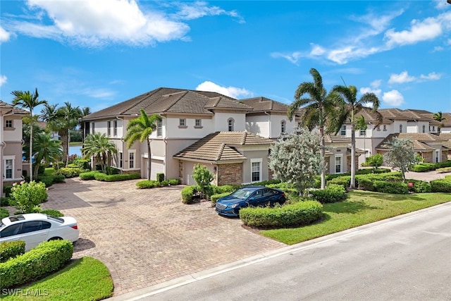 mediterranean / spanish-style house with a front yard