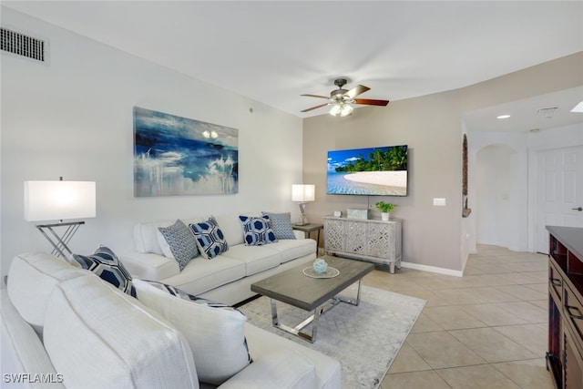 tiled living room with ceiling fan