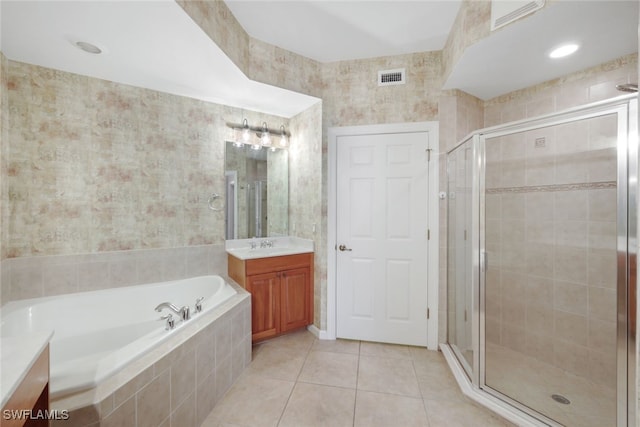 bathroom with vanity, independent shower and bath, and tile patterned flooring