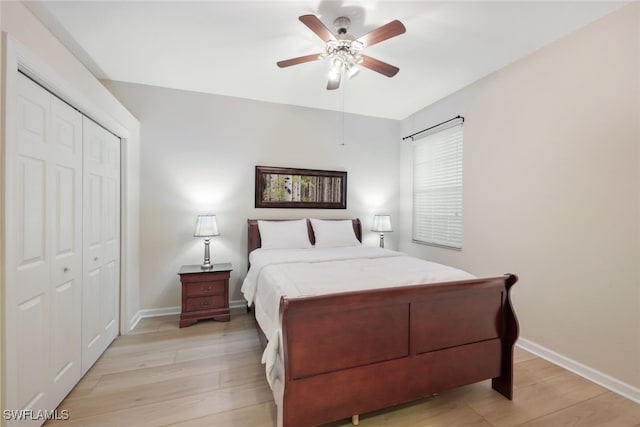 bedroom featuring a closet, light hardwood / wood-style floors, and ceiling fan