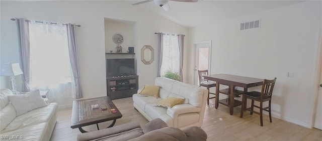 living room featuring lofted ceiling, light hardwood / wood-style floors, and ceiling fan