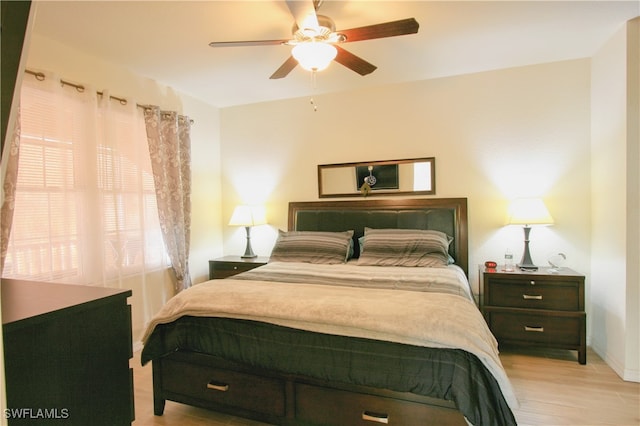 bedroom with light hardwood / wood-style floors and ceiling fan