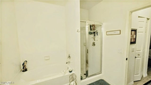 bathroom featuring separate shower and tub