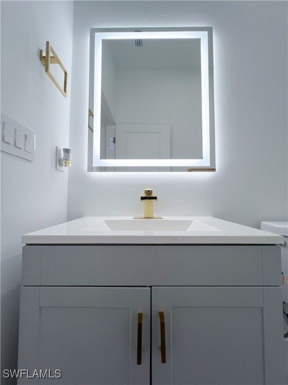 bathroom with vanity and toilet