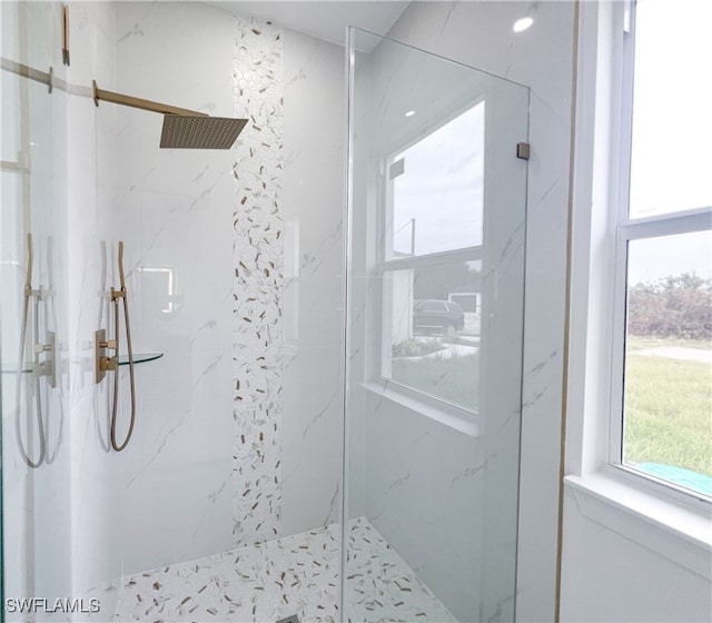 bathroom featuring a shower with shower door