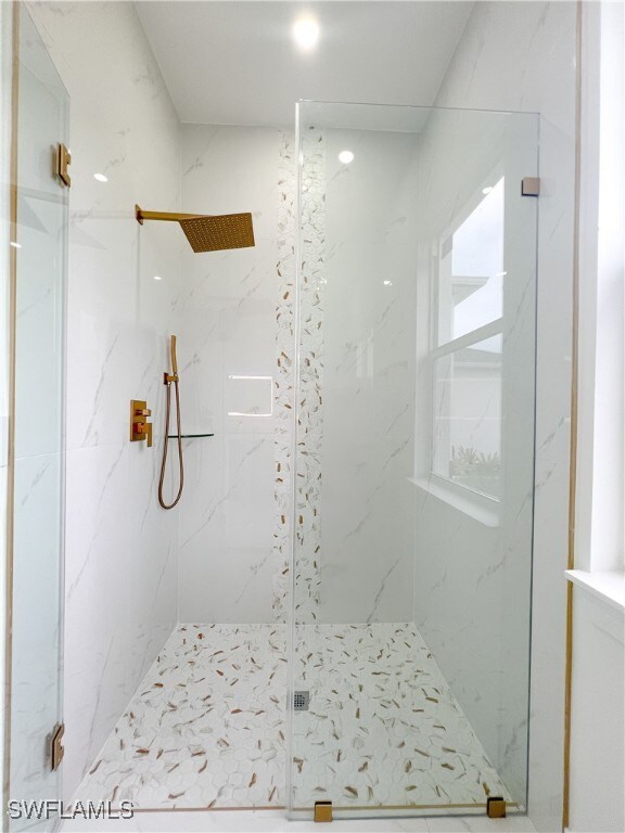 bathroom with a shower with shower door