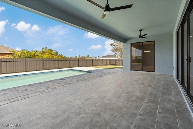 view of swimming pool featuring a patio area and ceiling fan