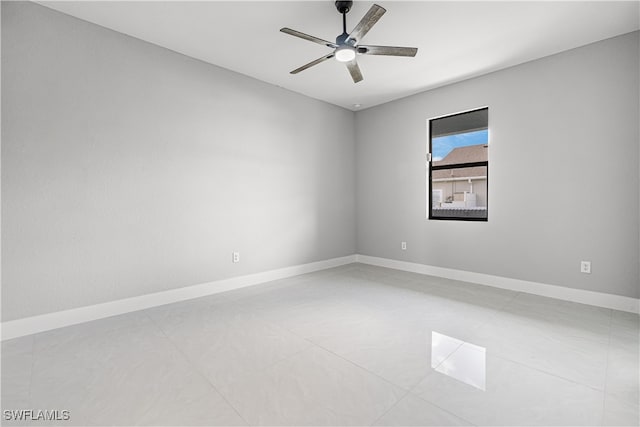 spare room featuring ceiling fan and light tile patterned floors