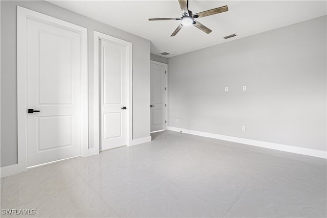 unfurnished bedroom with light tile patterned floors and ceiling fan