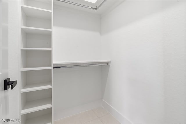 spacious closet with light tile patterned floors