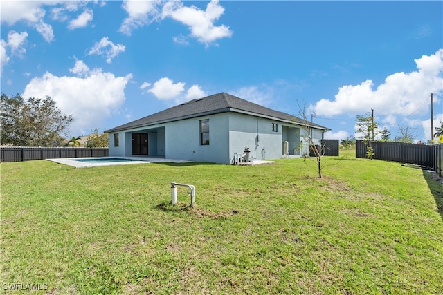 back of house featuring a yard and a patio area