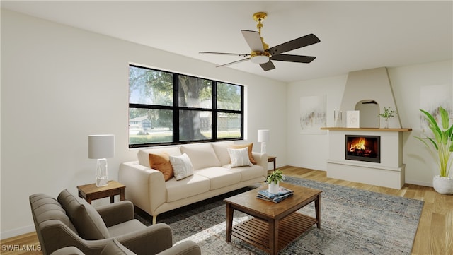 living room with a fireplace, ceiling fan, and light hardwood / wood-style flooring