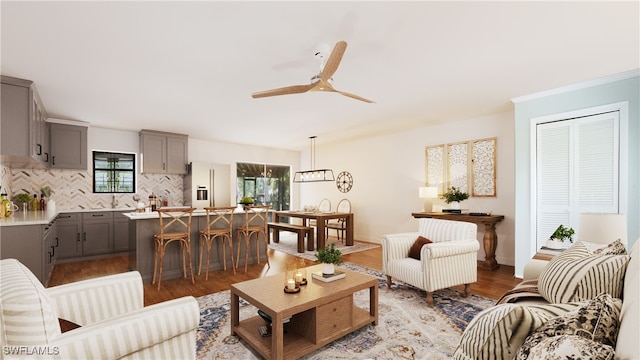 living room featuring light wood-type flooring and ceiling fan