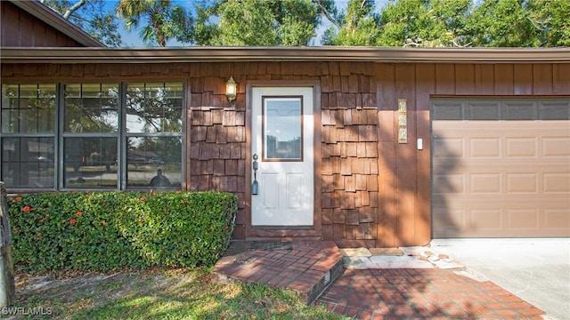 doorway to property with a garage