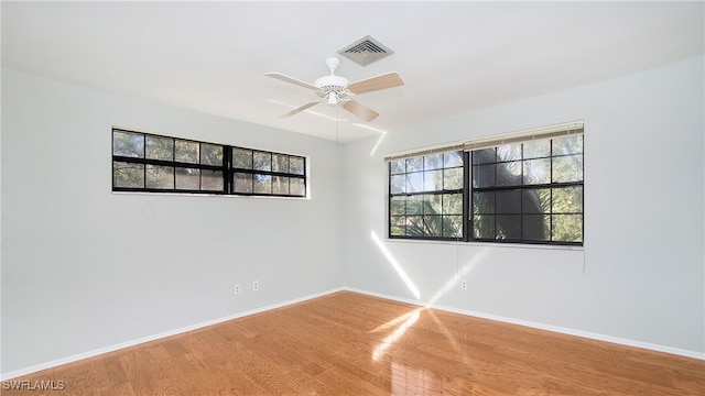 unfurnished room with ceiling fan and wood-type flooring