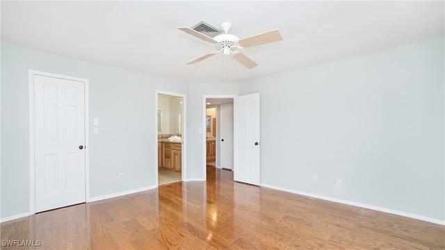 empty room featuring ceiling fan and light wood-type flooring