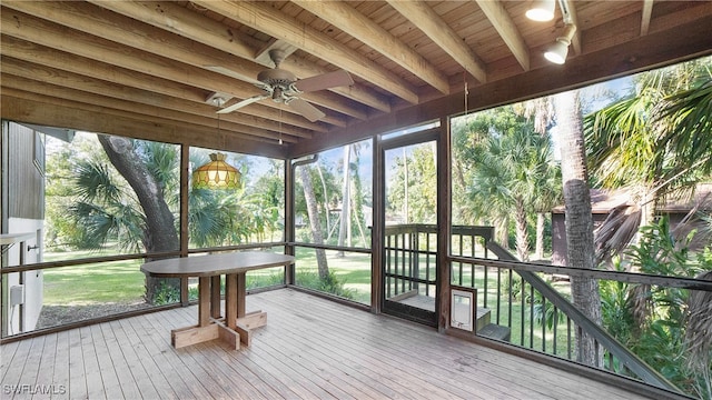 sunroom / solarium featuring ceiling fan, beam ceiling, and wooden ceiling