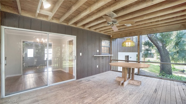 sunroom / solarium featuring ceiling fan with notable chandelier, beam ceiling, and wooden ceiling