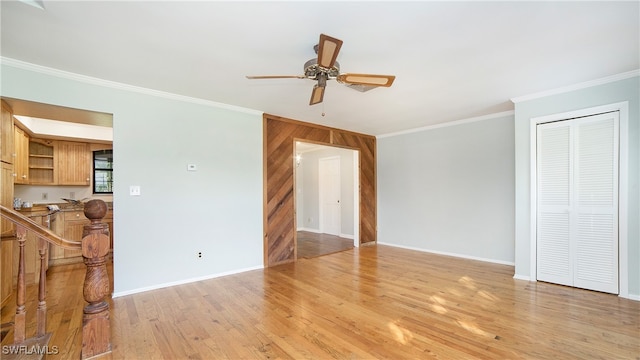 unfurnished living room with ceiling fan, light hardwood / wood-style flooring, and ornamental molding