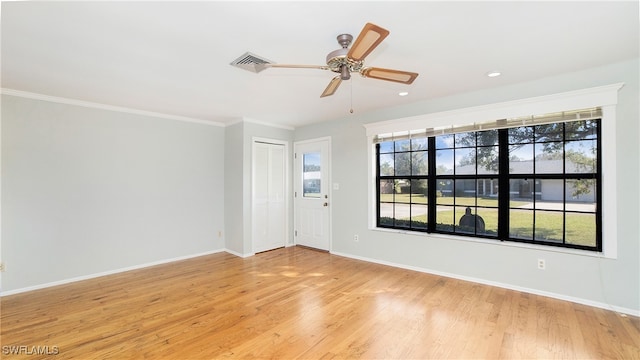 empty room featuring ornamental molding, light hardwood / wood-style floors, and ceiling fan