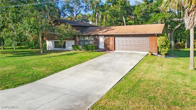 view of front of house featuring a garage and a front lawn