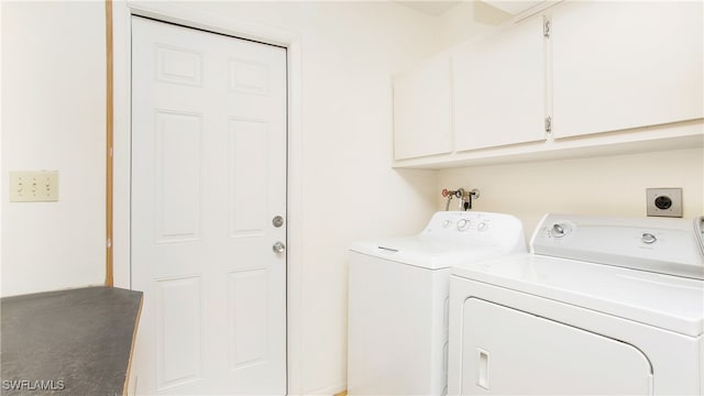 laundry area featuring cabinets and separate washer and dryer