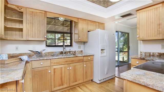 kitchen with white fridge with ice dispenser, light wood-type flooring, a wealth of natural light, and sink