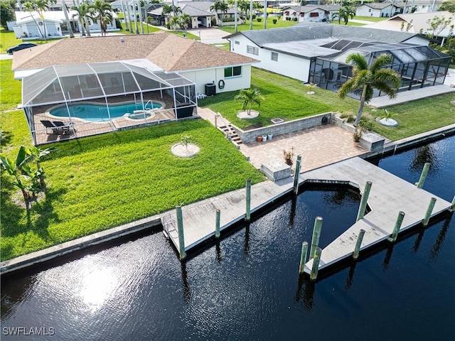 view of dock with a lanai, a lawn, a patio area, and a water view