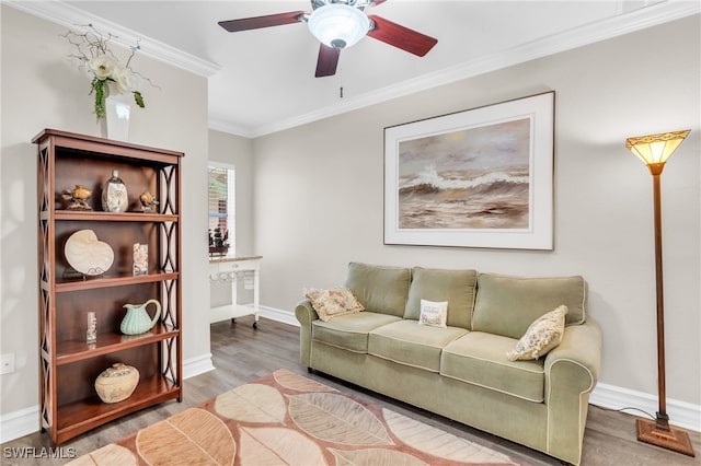 living room with ornamental molding, wood-type flooring, and ceiling fan