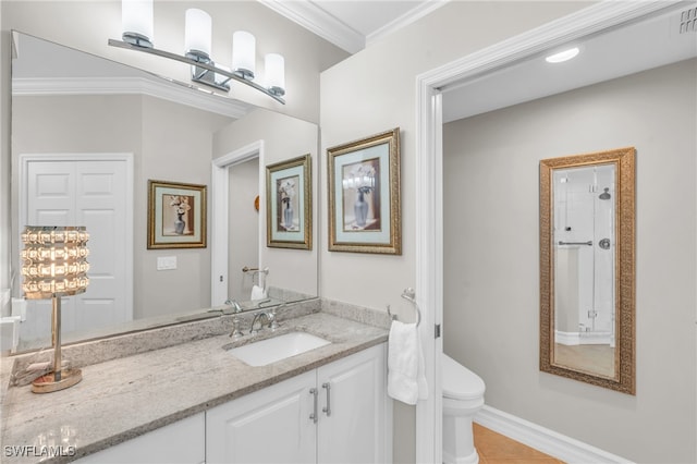 bathroom with toilet, ornamental molding, vanity, and tile patterned flooring