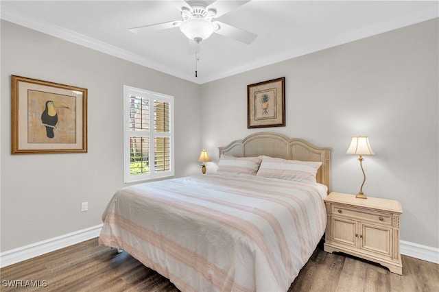 bedroom with crown molding, ceiling fan, and dark hardwood / wood-style flooring