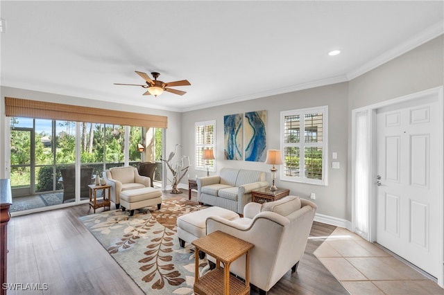 living room featuring ceiling fan, ornamental molding, and hardwood / wood-style floors